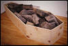 "Nonsite Coffin for Robert Smithson Filled with Rocks from the Amarillo Ramp" 1981-3, pine, rocks, 77" x 32" x 20"