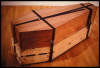 "Artist's Coffin with Extra One Tied Underneath to Contain Art Critic" 1981-3, top: mahogany, bottom: pine, nylon strap, 82"x34"x32"